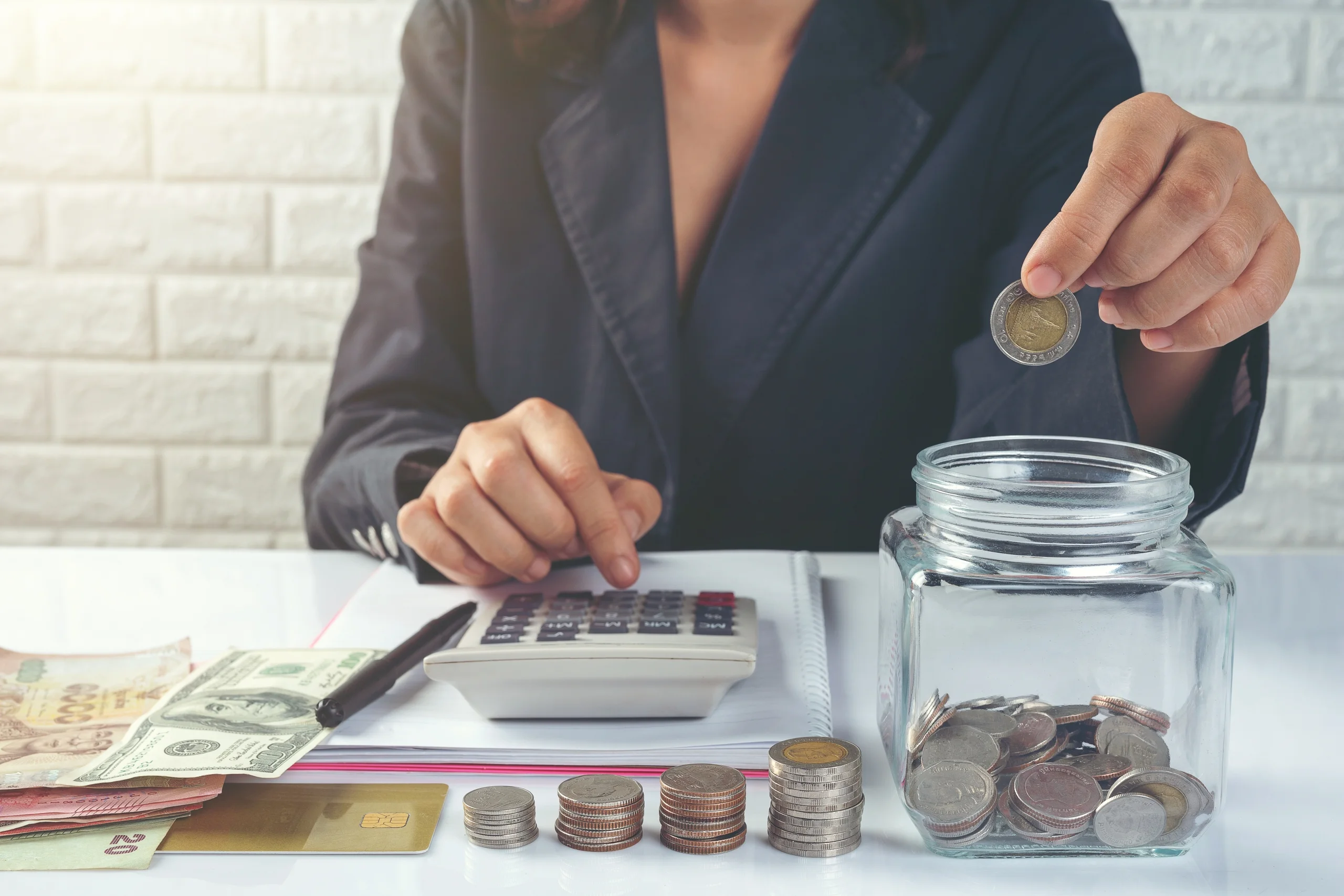 Business woman calculating income on desk